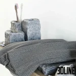 High-detail 3D model of a natural stone bathroom accessory set including soap dispenser, toothbrush holder, and towels