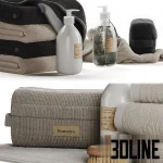 Detailed 3D model set of bathroom accessories, including stacks of folded Bonsoirs towels in neutral tones, pump-dispenser soap bottles, toiletry bags, and natural bristle brushes.
