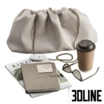 3D model of a fashion lifestyle set including a beige gathered leather clutch bag with chain, sunglasses, a coffee cup, a notebook, and a Kinfolk magazine.