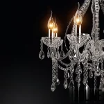 3D model of a classic Laudarte crystal chandelier, featuring a central glass column, curved glass arms holding candle-style bulbs, and hanging crystal teardrop pendants.