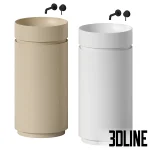 3D model of the NIC Design Mod freestanding washbasin, featuring a cylindrical body with a unique side cutout revealing internal shelving, shown in matte white and beige finishes with wall-mounted faucets.