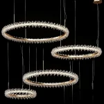 Detailed 3D model set of four THERA crystal ring chandeliers, featuring multiple gold circular frames densely covered in reflective crystal shards and integrated LED lighting.