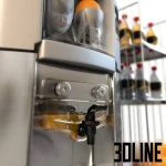 Detailed 3D model of the Zummo Z14 commercial orange juicer on a stainless steel cabinet base, including oranges and bottled juice accessories.