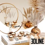 3D model of a luxury decor set featuring a round gold-rimmed mirror, a vase with fluffy pampas grass, gold candle holders, and a stack of fashion books including Louis Vuitton.
